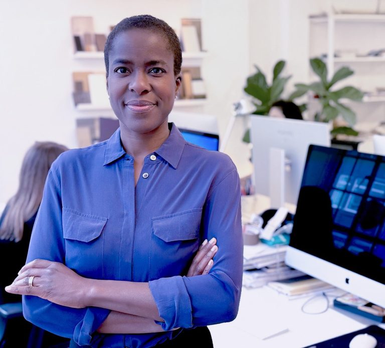 Lara Akeju headshot, standing in workplace